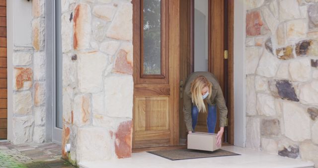 Woman Wearing Mask Receiving Delivery Package at Home Entrance - Download Free Stock Images Pikwizard.com