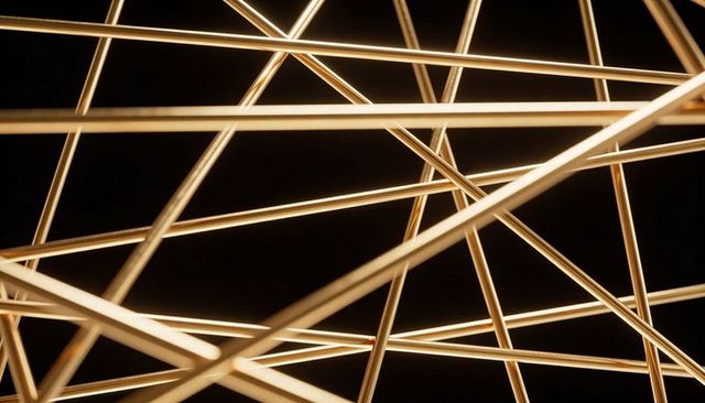 Glowing warm-white led rods crossing into minimalist geometric lattice installation