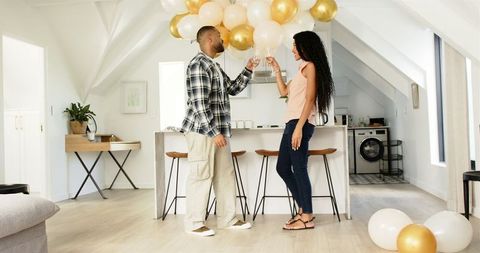 Couple Enjoying Post-Party Cleanup in Modern Home Interior