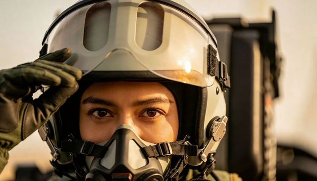 Female fighter pilot adjusting helmet visor and oxygen mask, close-up jet cockpit portrait