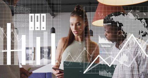 Team reviewing data visualizations on tablet and documents in modern open-plan workspace