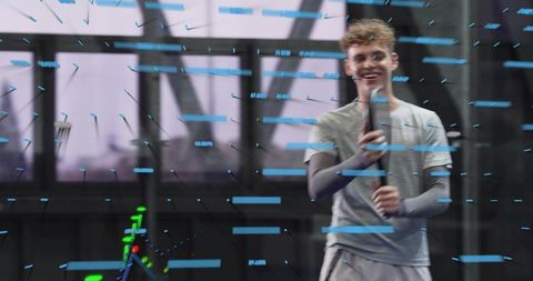 Young athlete holding smartphone demonstrating augmented reality fitness interface in gym