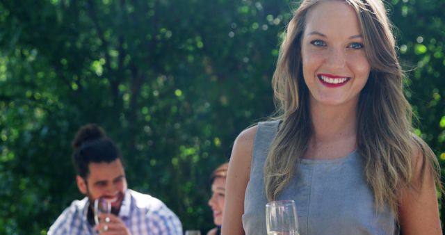 Smiling Woman Enjoying Champagne with Friends Outdoors - Download Free Stock Images Pikwizard.com