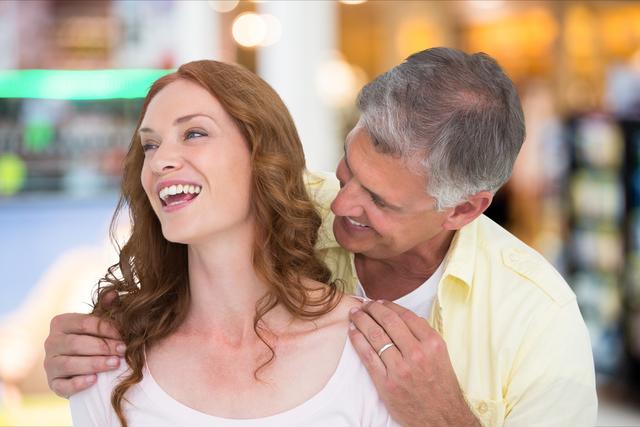 Perfect for advertisements, lifestyle blogs, articles about relationships or mature love, senior dating services promotions, and family-oriented campaigns. Depicts joy, affection, and happiness in an indoor retail setting.