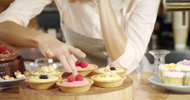 Pastry Chef Arranging Freshly Baked Fruit Tarts at Bakery Counter - Download Free Stock Images Pikwizard.com