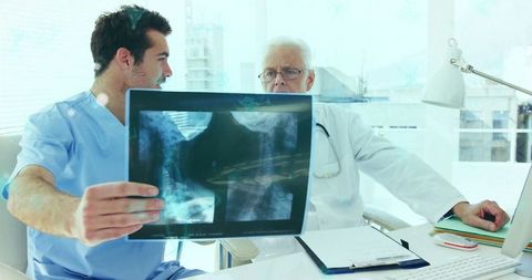 Medical Professionals Analyzing Spine X-ray on Modern Equipment
