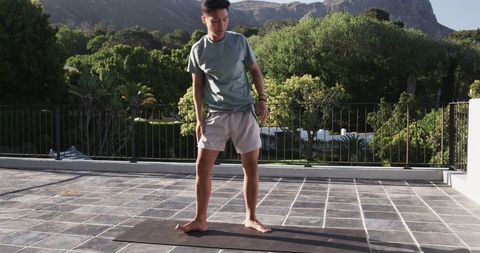 Man Exercising on Terrace with Scenic Mountain View