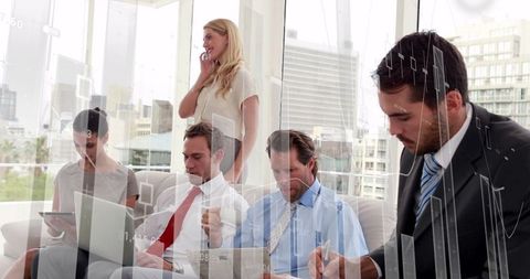 Financial Team Analyzing Data Amidst Graph and Chart Projections