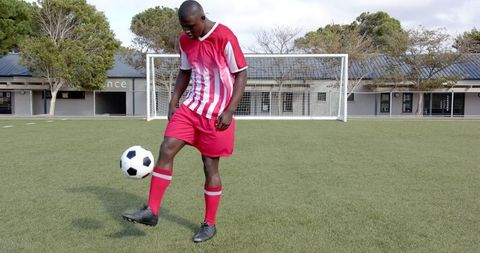 Soccer player practicing ball control on turf