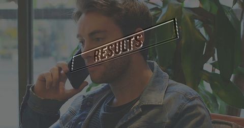 Casual man relaxed while talking on smartphone in cozy cafe setting