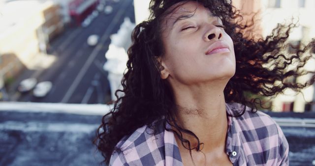 Young Woman Enjoying Sunlight on Rooftop - Download Free Stock Images Pikwizard.com