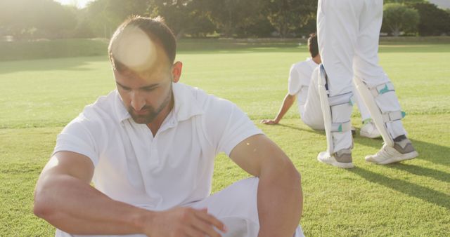 Tired Cricketer Taking a Break on the Field - Download Free Stock Images Pikwizard.com