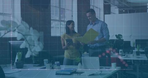 Colleagues Reviewing Data in Modern Office Environment