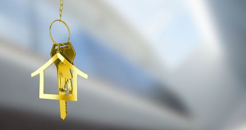 Golden house keychain symbolizing property ownership