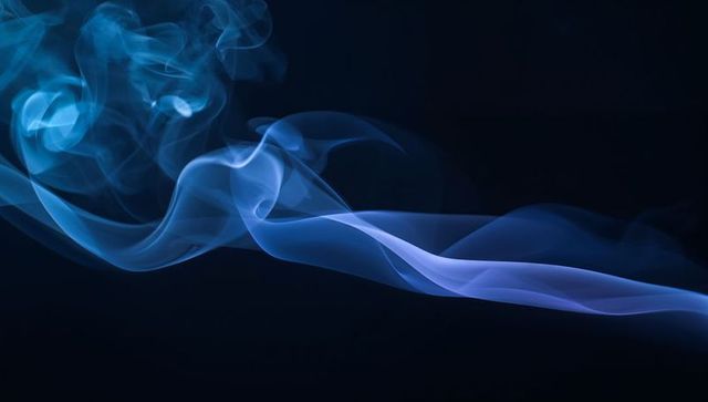 Cyan Lavender Smoke Ribbons Flowing Across Dark Background for Abstract Visuals