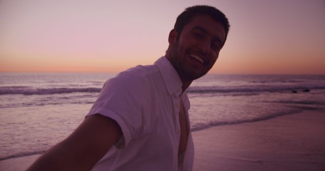 Man Smiling at Sunset on Beach - Download Free Stock Images Pikwizard.com