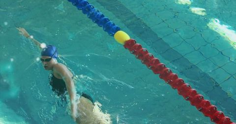 Swimmer gliding effortlessly in turquoise pool during competition