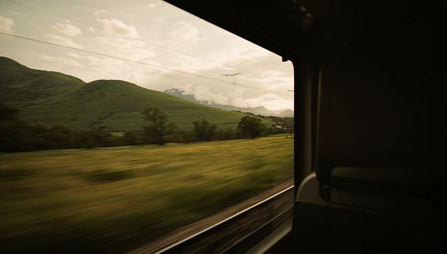 Scenic train journey through lush countryside at gentle speed