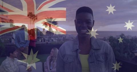 Joyful man on sunset rooftop with superimposed australian flag
