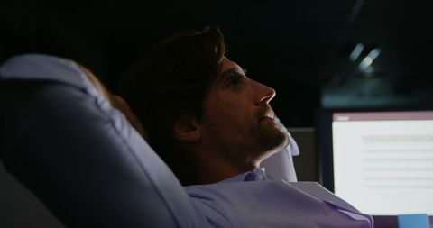 Contemplative young executive analyzing data in modern office