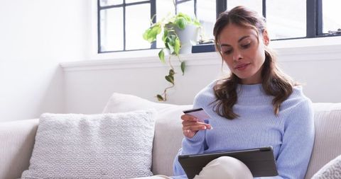 Modern Woman Shopping Online with Tablet and Credit Card, Relaxed in Comfort
