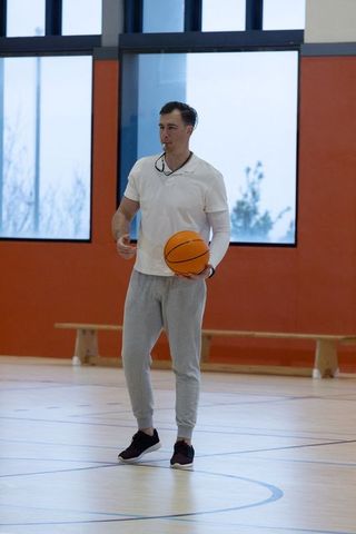 Basketball Coach Holding Tool for Athlete Motivation on Court