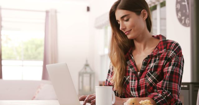 Young Woman Working on Laptop at Home with Coffee - Download Free Stock Images Pikwizard.com