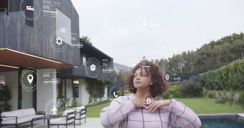 Young woman interacting with augmented reality hud in modern backyard pool patio smart home tech