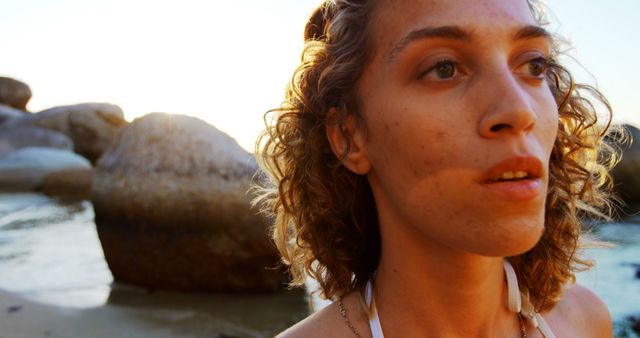 Woman Contemplating at Sunset on Rocky Beach - Download Free Stock Images Pikwizard.com