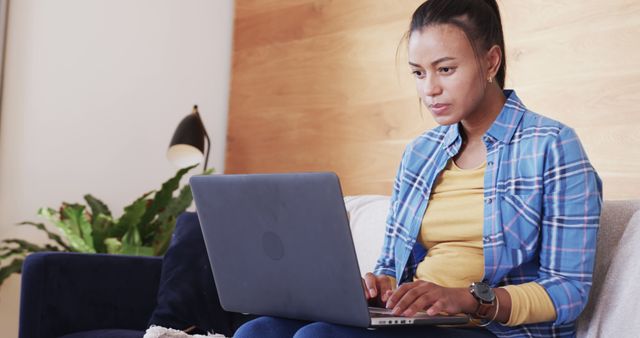 Young Woman Focused on Laptop While Working from Cozy Home - Download Free Stock Images Pikwizard.com