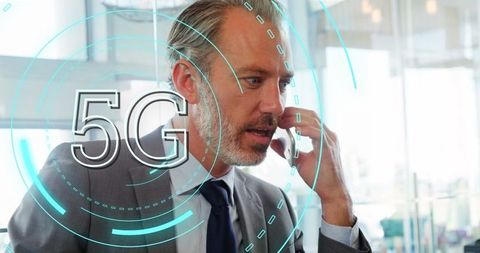 Businessman Utilizing 5G Technology on Smartphone in Modern Office