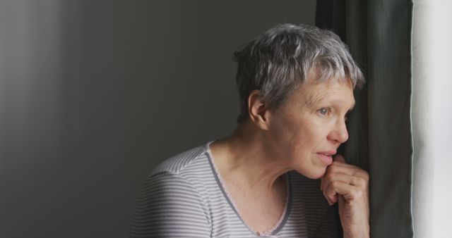 Older Woman Looking Thoughtfully Out Window with Hand on Chin - Download Free Stock Images Pikwizard.com