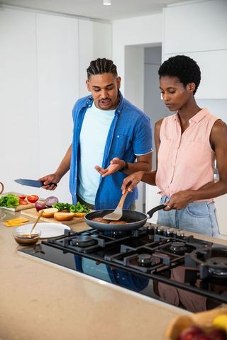 Diverse Couples Cooking Teamwork Making Burgers in Modern Home Kitchen