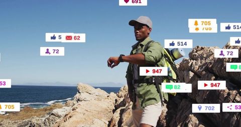 Hiker Using Smartwatch with Social Media Overlay on Rocky Shore