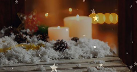 Festive winter candles and pine cones creating warm ambiance