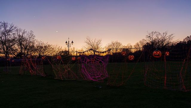 Glowing Halloween Decorations in Park at Dusk