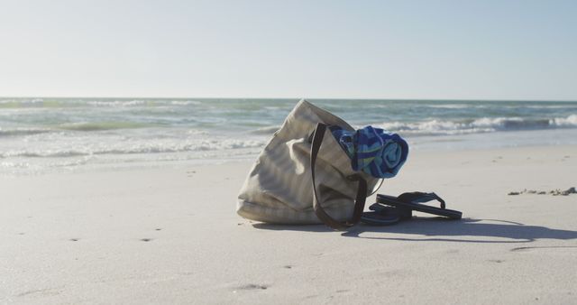 Image of bag with beach equipment lying on sand on beach. Holidays, vacations, relax and summer concept.