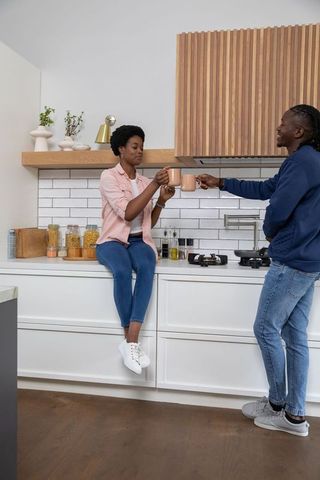 Couple enjoying coffee in cozy kitchen environment