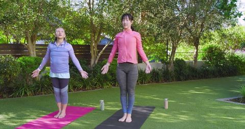 mother and daughter practicing yoga outdoors in serene garden - Download Free Stock Images Pikwizard.com