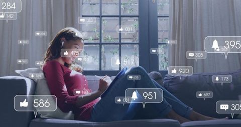 Woman working from home on tablet and notebook with social media notifications overlay
