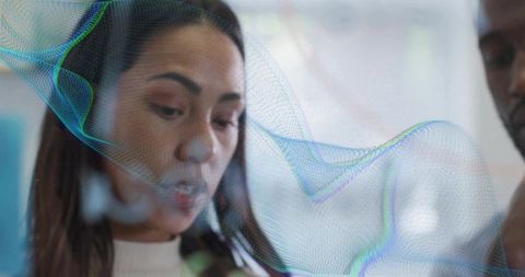 Woman explaining strategy on transparent display with holographic data overlay