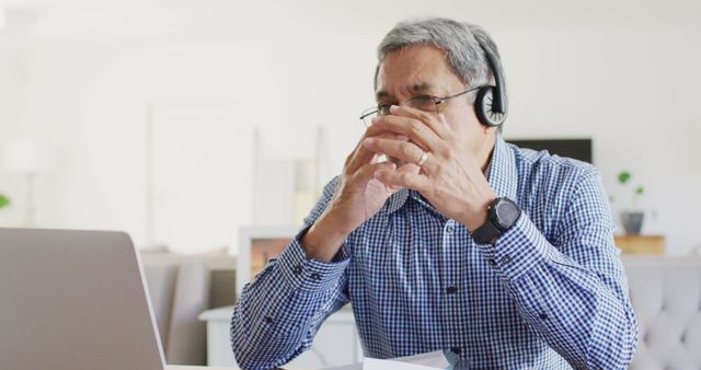 Senior Man Using Laptop While Wearing Headphones Working From Home - Download Free Stock Images Pikwizard.com