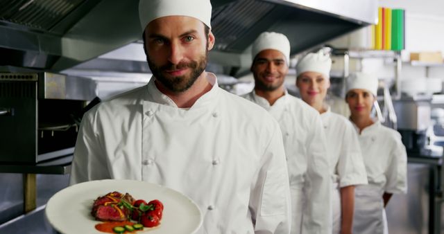 Team of professional chefs presenting gourmet dish in commercial kitchen - Download Free Stock Images Pikwizard.com