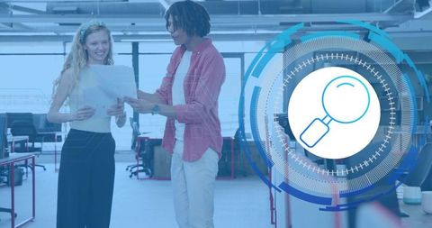 Two coworkers reviewing documents in modern open-plan office with magnifier overlay