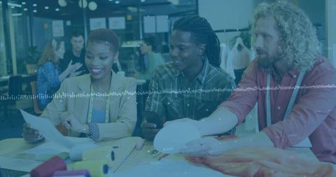 Creative Designers Collaborating in Fashion Studio