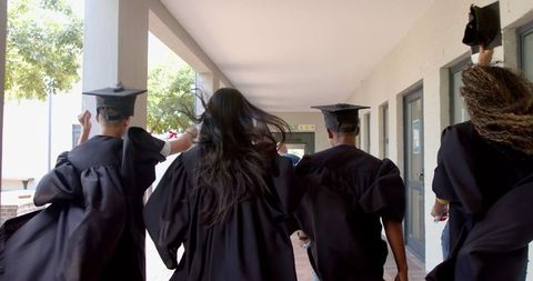Diverse Graduates Celebrating Success in Caps and Gowns - Download Free Stock Images Pikwizard.com