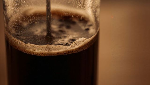 Rich brew in french press coffee maker with crema and venetation effects