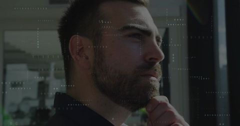 Contemplative Businessman at Office Window with Digital Binary Code Overlay