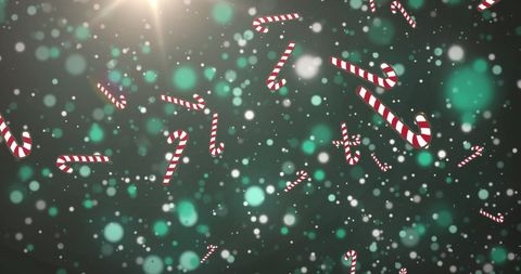 Festive Falling Candy Canes Over Green Bokeh Lights