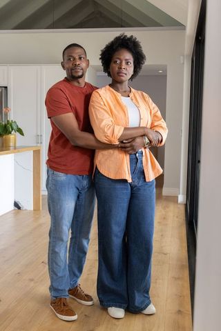 African american couple embracing in modern vaulted kitchen, calm intimate home lifestyle